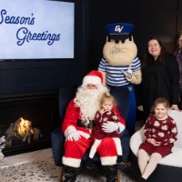 two little girls with red dressed and family with Louie and Santa